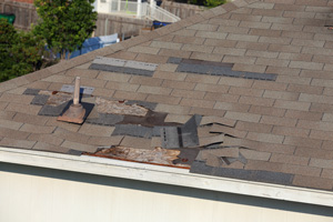 Damaged roof shingles in need of repair